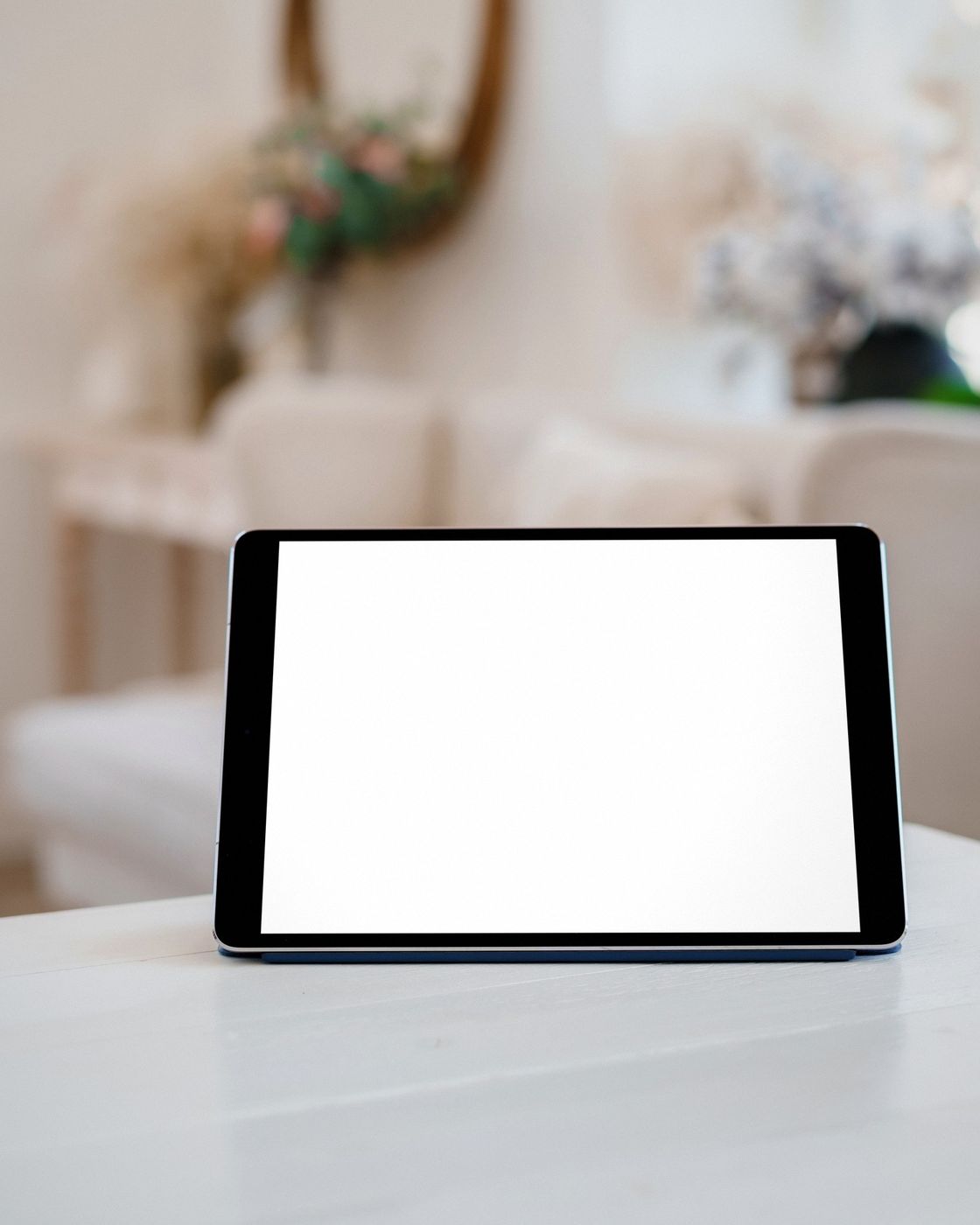 A reader with a tablet displaying an eBook beside a cup of coffee