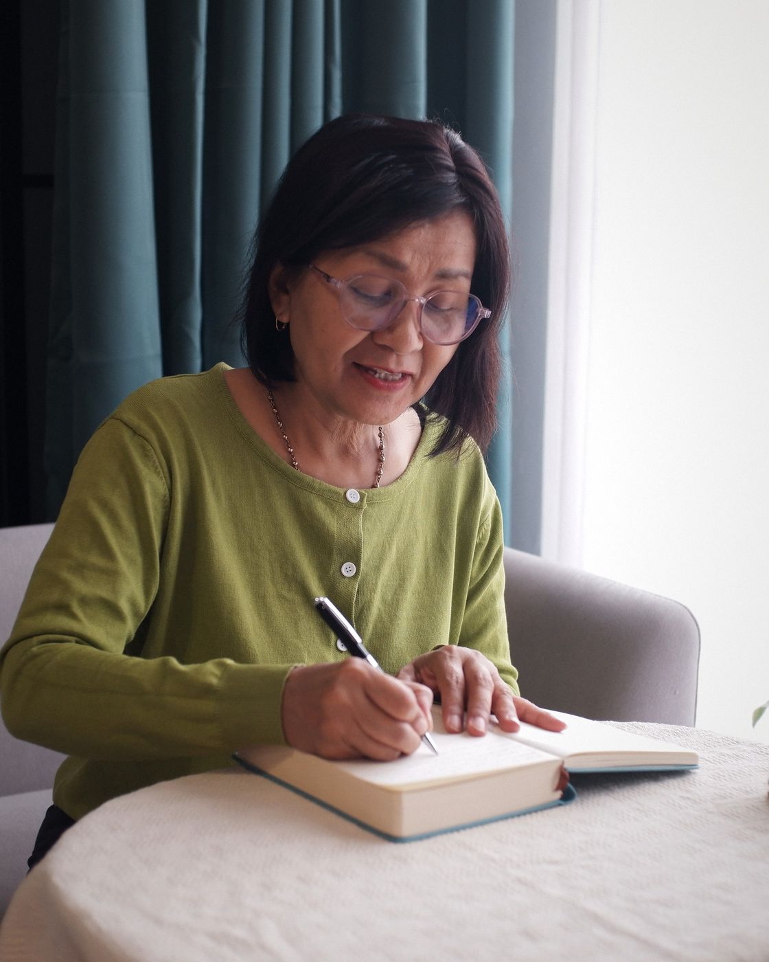 A fountain pen resting on a page of handwritten red-ink edits