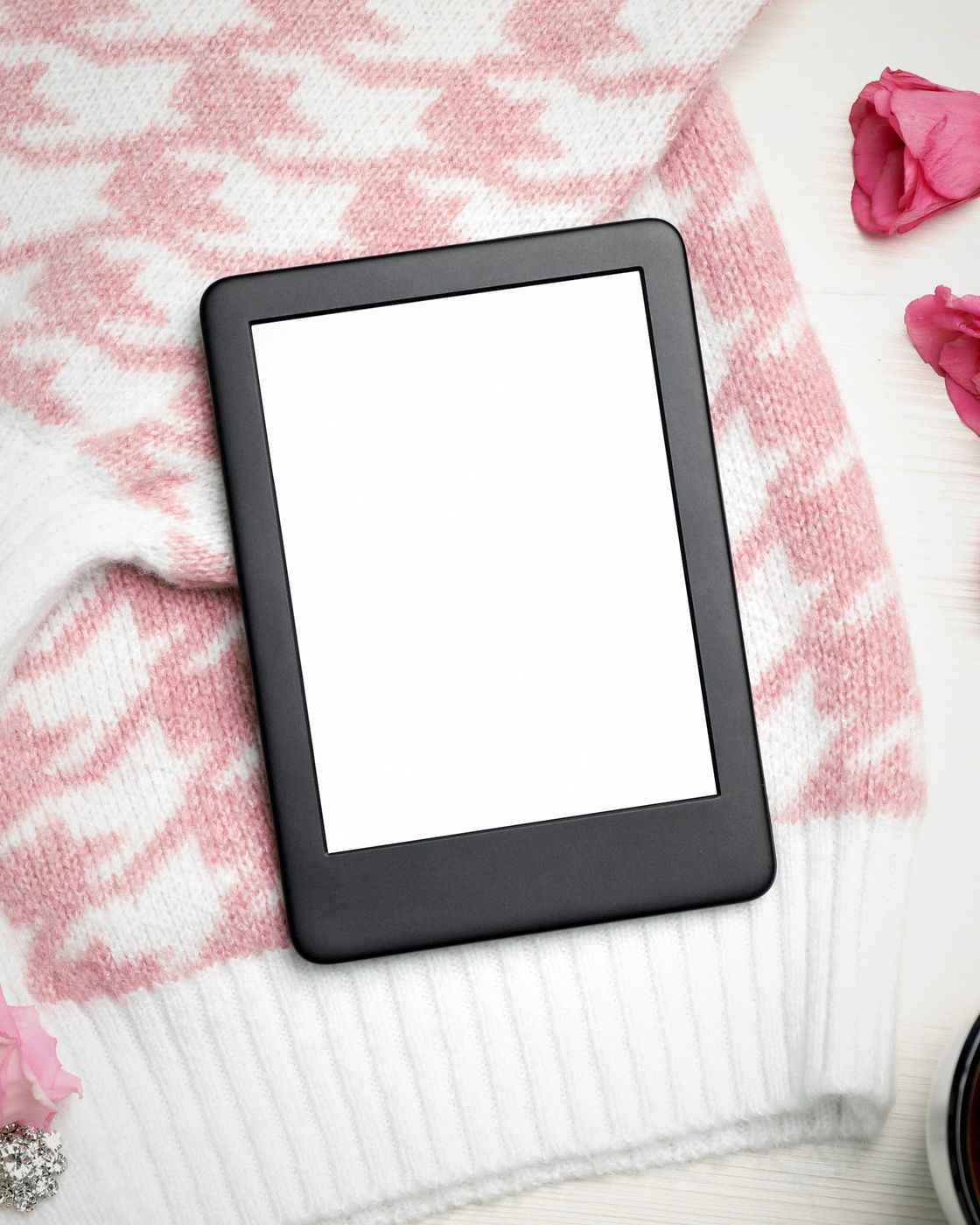 A reader with a tablet displaying an eBook beside a cup of coffee