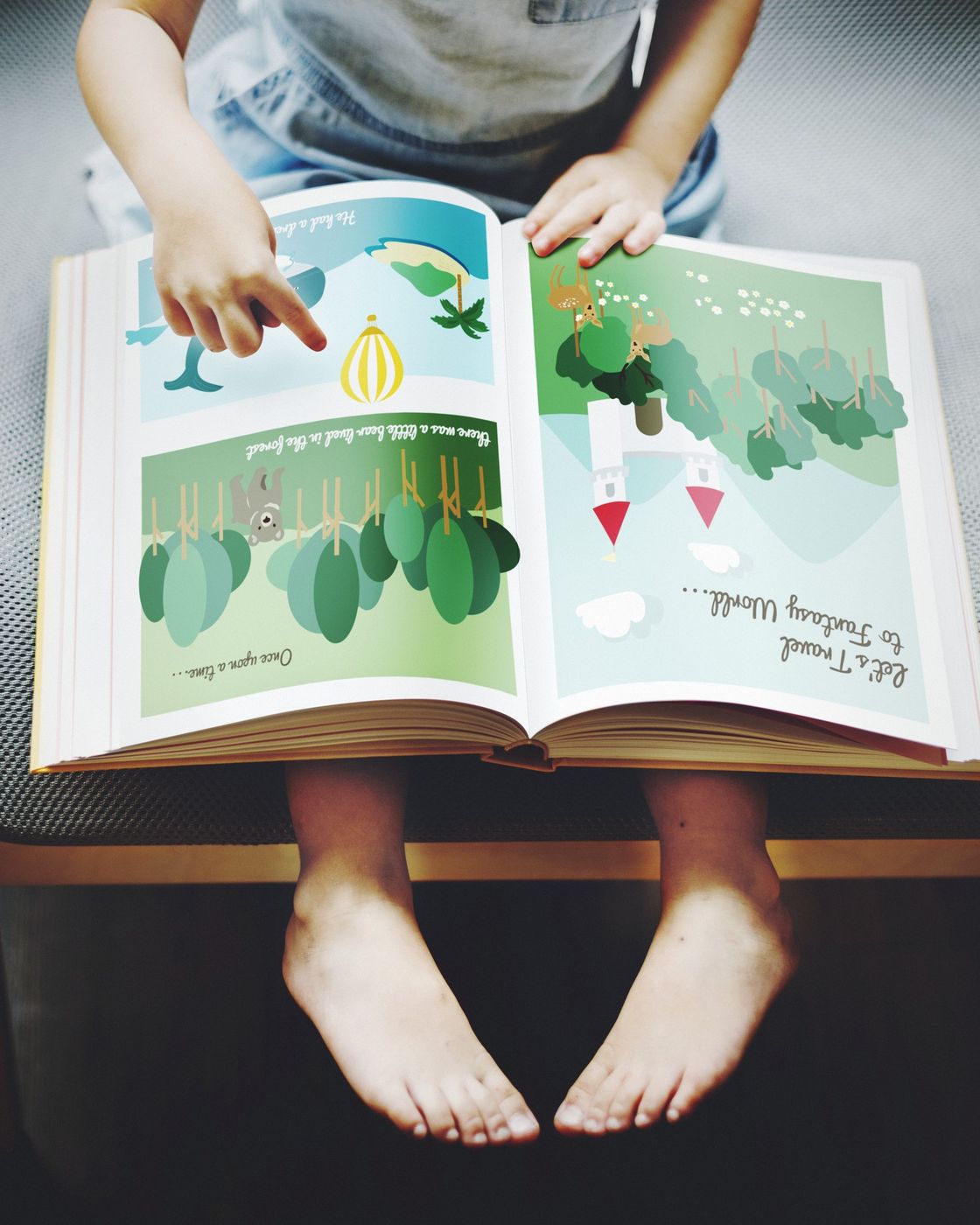 A child reading a whimsical illustrated picture book