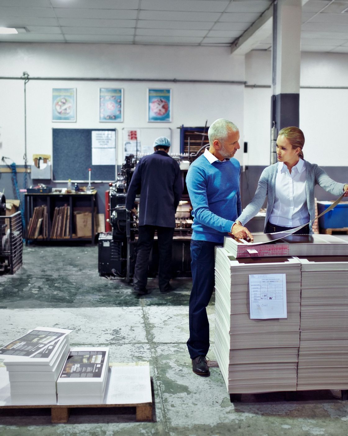 Stacks of freshly printed paper at a commercial print shop