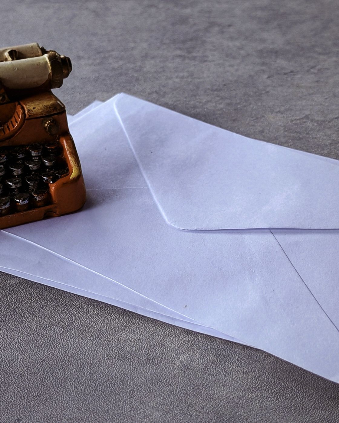 A fountain pen resting on a page of handwritten red-ink edits