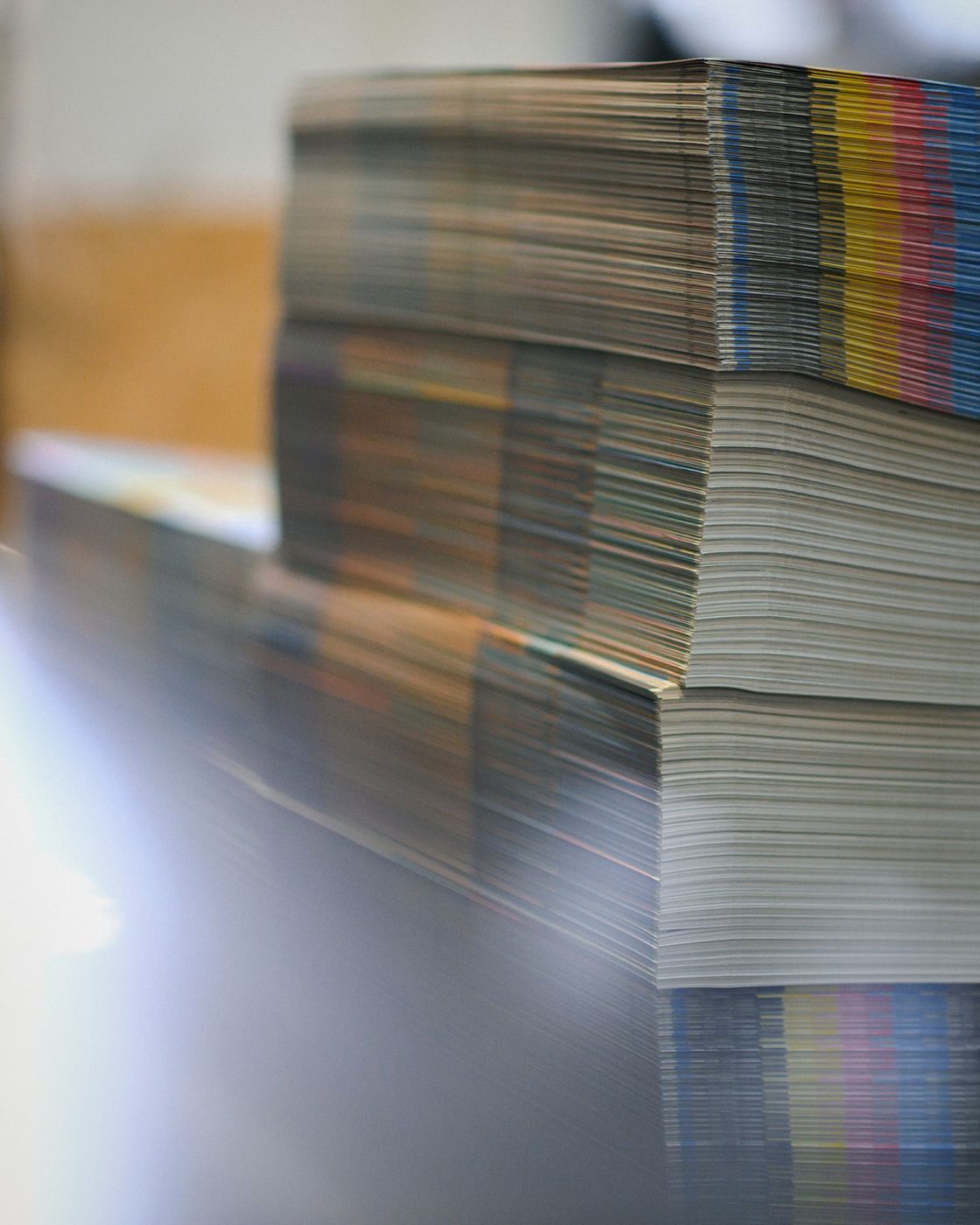 Stacks of freshly printed paper at a commercial print shop
