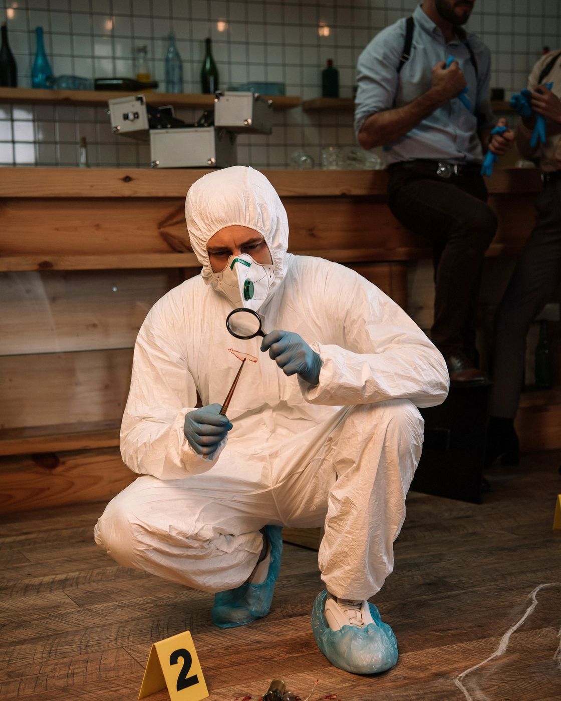A crime scene investigator examining evidence with a magnifying glass